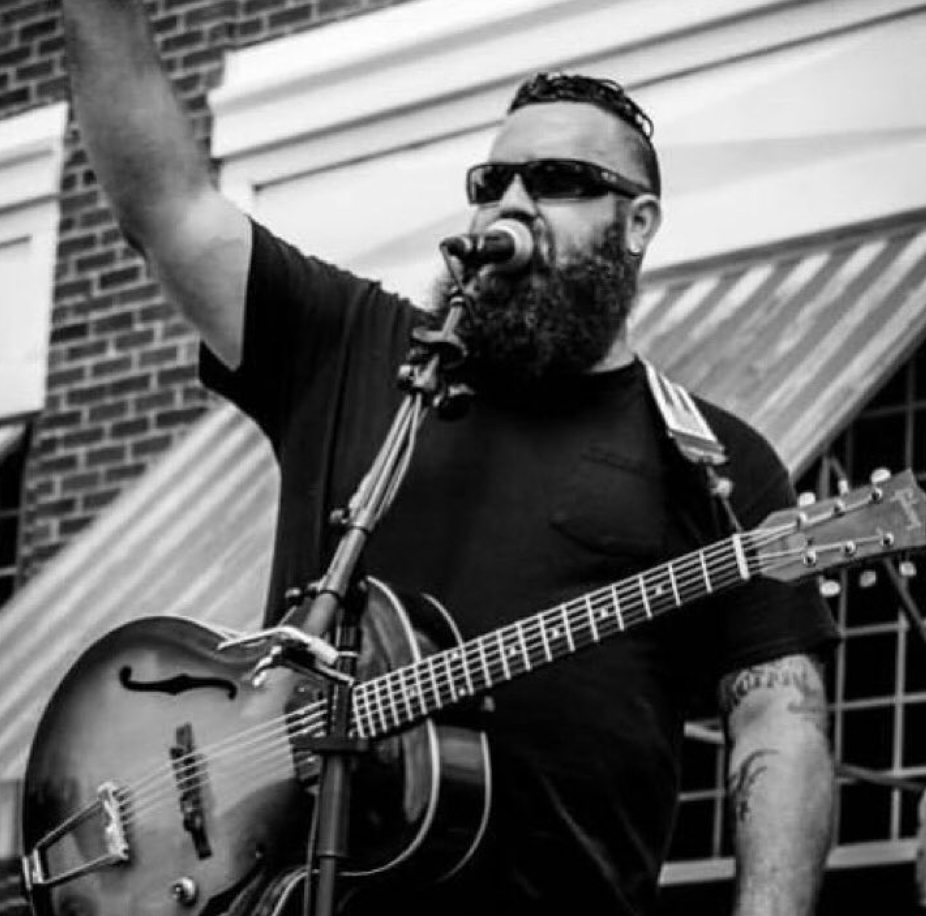 Doc Perkins performing acoustic folk music.