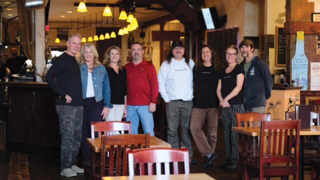 The past and current set of 4 couples that have owned Outer Banks Brewing Station